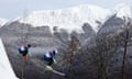 Anton Grimus and Scott Kneller of Australia jump during a ski cross training session.