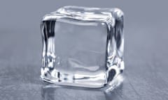 A completely transparent ice cube on a table 