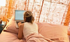 Woman Using Laptop in Bed