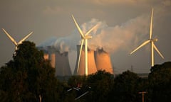 Wind turbines next to cooling towers