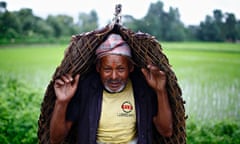 A farmer covers himself from the rain during Asar Pandra festival in Bhaktapur