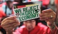 Protester with sign rejecting the "greed economy"