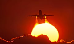 Exhaust from the engines of an Air Canada 737 taking off at sunset.