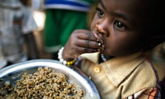 A child eating lentils in Rwanda 