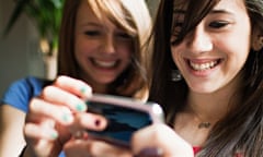 Two teenage girls using smartphone