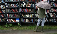 woman wearing wellies looks at books