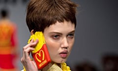 Model Lindsey Wixson holds the Moschino iPhone case