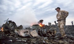 People walk amongst the debris of Malaysia Airlines flight MH17 near the village of Grabovo in Ukraine.