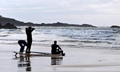 Surfers on the beach at St Ives, Cornwall.