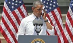 President Barack Obama wipes perspiration from his face as he speaks about climate change