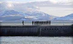 British Navy personnel stand atop the Trident nuclear submarine, HMS Victorious, on patrol off the west coast of Scotland in April 2013.