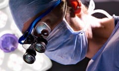 Concentrating surgeon performing operation in operating room