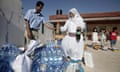 A Palestinian volunteer receives goods f