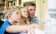 father and child looking at computer screen