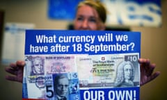 A yes campaign volunteer displays a campaign leaflet in the runup to the vote on 18 September