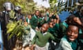 Pupils from Langata Road primary school run past riot police as they try to reclaim their playground.