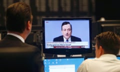 Traders in Frankfurt watch the ECB press conference. Photo: Reuters/Ralph Orlowski