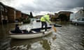 Residents make their way through floodwater that has cut off their homes in Chertsey in 2014