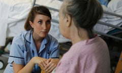 A nurse with a patient on the stroke ward at Hinchingbrooke