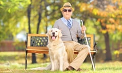 older man sitting on bench with white cane