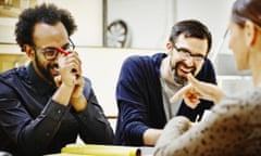 Laughing architects at conference table in office