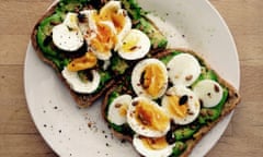 Avocado and soft boiled egg on toast with seeds.