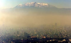 Pollution blankets Mexico city against a backdrop of the Ixtcihuatl volcano 18 January 2002.