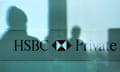 Silhouettes of passers-by reflected on the window of a branch of HSBC Private Bank (Suisse) in Genev