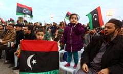 Libyans wave national flags on Martyrs' Square in Tripoli as hundreds of people demonstrated in support of the UN-brokered dialogue between warring factions.