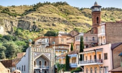 ornate buildings of Tbilisi with hills behind