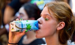 A model finishes her coconut water backstage at Fyodor Golan