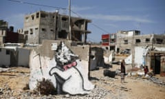 A mural of a playful-looking kitten, presumably painted by British street artist Banksy, is seen on the remains of a house that witnesses said was destroyed by Israeli shelling during the 50-day war last summer in the Gaza Strip.