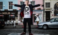 Bez in a Ramsgate street, arms open, wearing a Reality Party T-shirt