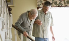 older man being helped downstairs