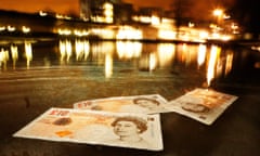 Bank of England ten pound notes float in front of The Scottish Parliament.