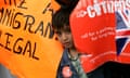 A child peers out during the migrant's day march for immigrant rights in Trafalgar Square
