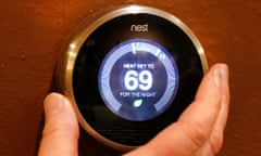 A man's hand controlling Google Nest.