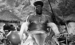An African tribal chief sits on his throne in a scene from the film Rhodes of Africa