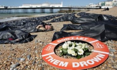Protesters from Amnesty International in body bags on Brighton beach