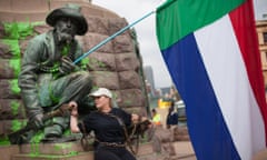 Afrikaans singer Sunette Bridges chains herself to a vandalised statue of Paul Kruger in Church Square in Pretoria, South Africa.