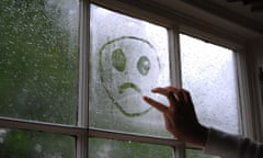 Sad face drawn on a window