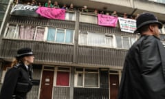 Police walk past as activists from Housing Action Southwark and Lambeth resist a family’s eviction from a flat in an estate had been marked for demolition.