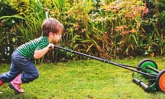 A boy mowing a lawn