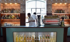 Waiters work in a bar designed by US film director Wes Anderson recreating the old Milan cafes' atmosphere in the new venue of Prada's Foundation on May 2, 2015 in Milan.