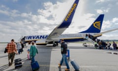 Passengers walking towards a Ryanair plane