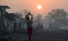 TOPSHOTS This photo taken on March 18, 2015 shows a migrant labourer carrying a bottle of water he filled from a water tanker at the camp where he and others like him live in the Dwarka sector of New Delhi on March 18, 2015.  A new UN report launched in New Delhi on March 20 ahead of World Water Day on March 22 warned of an urgent need to manage the world's water more sustainably and highlight the problem of groundwater over-extraction, particularly in India and China. The report says global demand for water is increasing exponentially, driven largely by population growth.   AFP PHOTO / Roberto SCHMIDTROBERTO SCHMIDT/AFP/Getty ImagesHORIZONTALLIGHTINGSUNMANFETCHING WATERON ONE'S HEAD