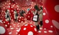 Reflected in a mirror, a woman views an exhibition in the Garage Museum of Contemporary Art at a preview opening of a new museum building in Moscow, Russia, Wednesday, June 10, 2015.  (AP Photo/Pavel Golovkin)