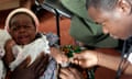 A child is given an injection as part of a malaria vaccine trial 