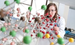 female scientist with a DNA molecule model