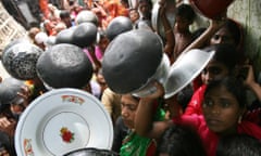 Flood affected women and children gather for food outside a relief camp in Keraniganj, Bangladesh.